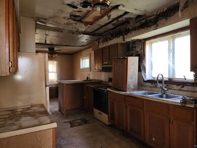 Kitchen with white fridge, premium range hood, ele