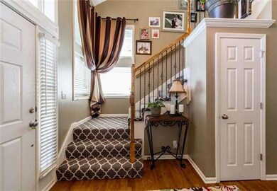 The foyer staircase, featuring handsome iron spind