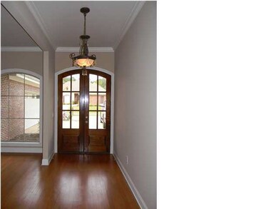 Formal entry with hardwood floors
