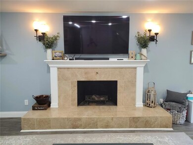 Dramatic fireplace in great room. Marble tile. Rai