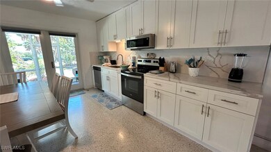 Kitchen featuring light speckled floor, stainless