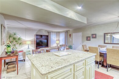 Island kitchen featuring granite counters, custom