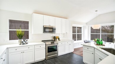 The dark statement tile on the kitchen floor perfe