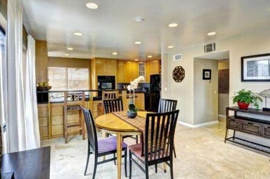 View of open kitchen, dining area, travertine floo