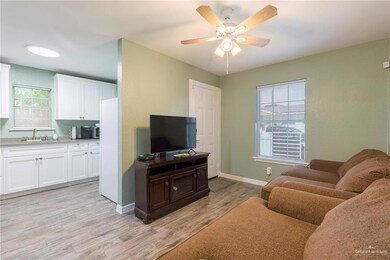Living room featuring light hardwood / wood-style flooring, sink, and ceiling fan