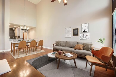 Living area featuring a high ceiling, wood finish