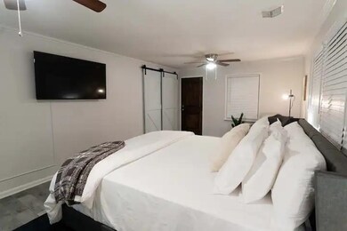 Bedroom with hardwood / wood-style flooring, a bar