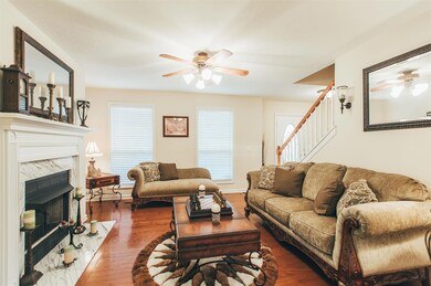 The formal Living room has hardwood flooring, and a gas log fireplace. It connects through double French glass doors to the Florida room.  