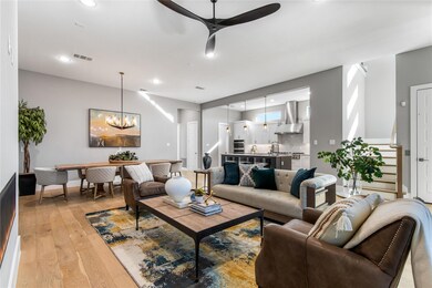 Living room featuring sink, ceiling fan with notab
