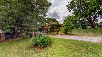 Spacious lot features lots of mature trees and shrubs.