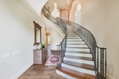 Enter through exquisite Mahogany double doors to soaring ceilings and sweeping wrought iron staircase enhanced with stunning crystal chandelier. *Virtually Renovated Flooring