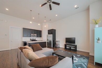 This spacious open-concept living area features ha