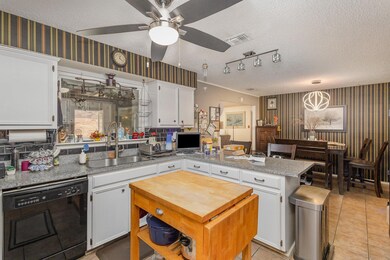 Kitchen featuring sink, a textured ceiling, white 