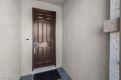 Property entrance featuring stucco siding