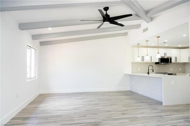 Kitchen with light countertops, stainless steel mi