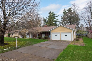 Ranch-style house with a garage and a front yard