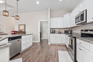 Kitchen with pendant lighting, light stone counter