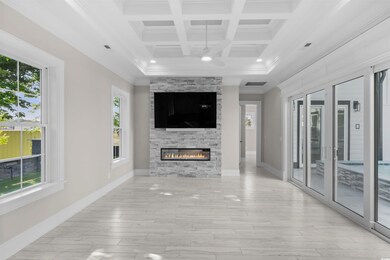 Unfurnished living room featuring a fireplace, a w