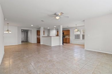 Unfurnished living room featuring recessed lighting, light tile patterned flooring, ceiling fan, and a chandelier