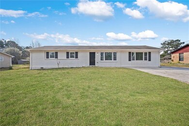 Ranch-style home with board and batten siding, a f
