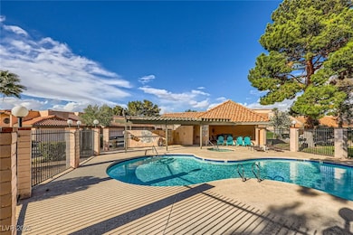 Community pool featuring a patio and fence