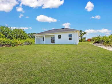 Rear view of property featuring a lawn