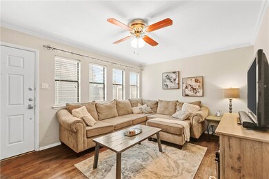Living area with crown molding, baseboards, a ceil