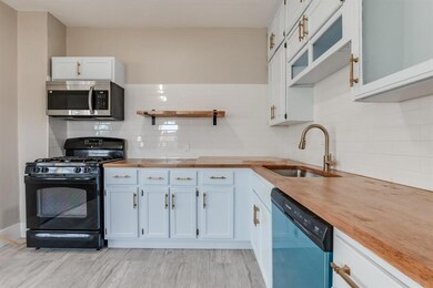 Kitchen featuring black gas range oven, dishwashin