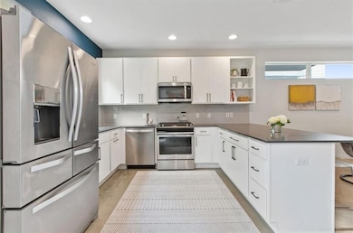 Kitchen with stainless steel appliances, a penins