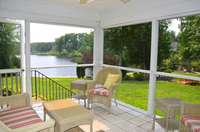 Screened porch off the sunroom/den with door to ra