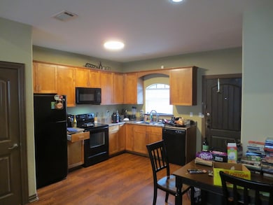 Kitchen with visible vents, a sink, black applianc