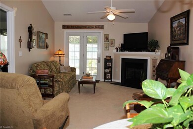 Living Room with gas fireplace, vaulted ceiling & ceiling fan!