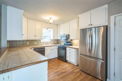 Kitchen featuring appliances with stainless steel