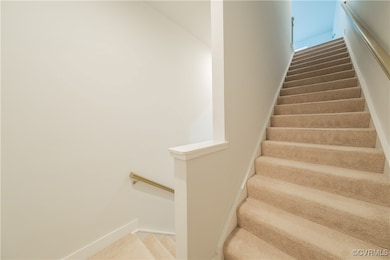 Stairs featuring baseboards and carpet