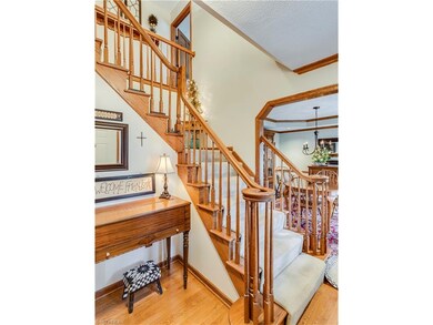 The two story foyer offers solid wood trim, hardwo