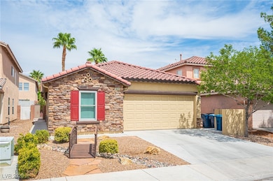Mediterranean / spanish home featuring driveway, a garage, stucco siding, a tile roof, and stone siding