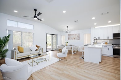 Living area featuring a chandelier, vaulted ceilin