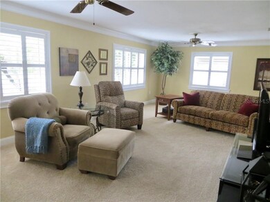 Formal living room has plantation shutters & crown