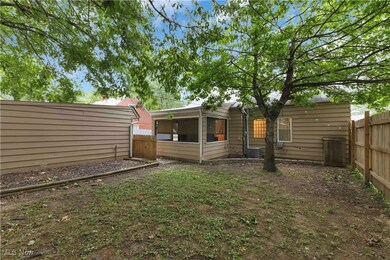 Fenced backyard with a sunroom