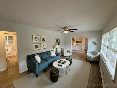 Living room with wood finished floors and ceiling fan