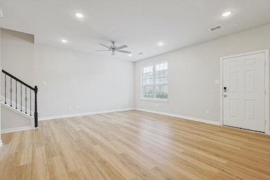 Unfurnished living room with ceiling fan and light wood-type flooring