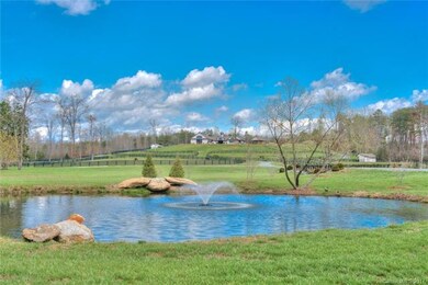 Sparkling pond at the forefront of the property we