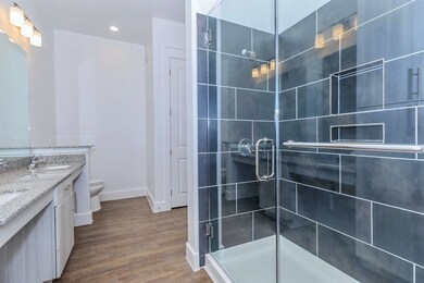 Bathroom with double sinks, granite countertops, a
