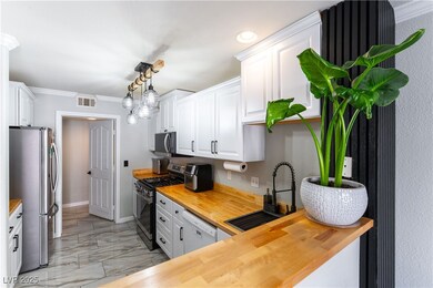 Kitchen featuring butcher block countertops, stain