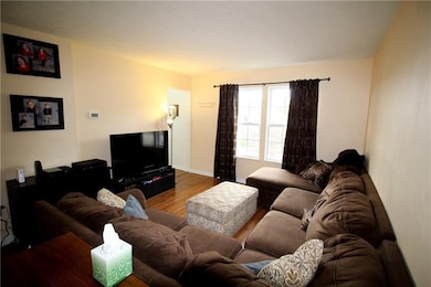 Family room has wood laminate flooring.