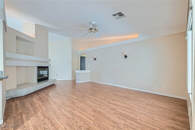 Unfurnished living room featuring baseboards, vaul