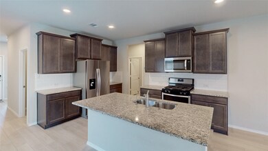 Kitchen with large island, granite counters, custo