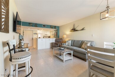 Living area with light tile patterned floors and v