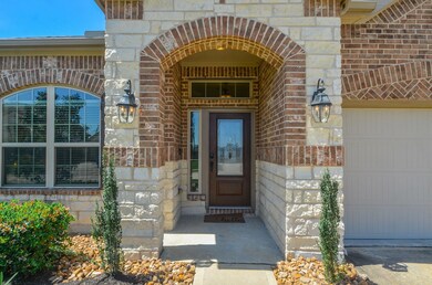 Brick work with arched design at window, front porch and garage.