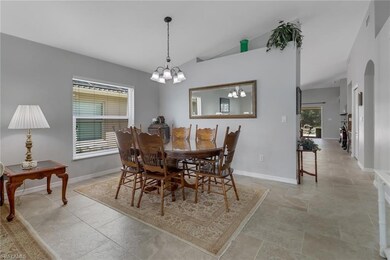 Dining space featuring a chandelier and vaulted ce